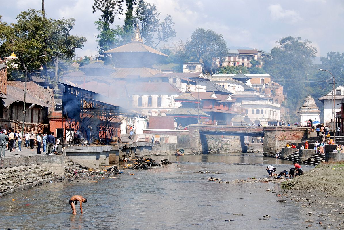 Kathmandu Pashupatinath 08 Pashupatinath Burning Ghats From Down The Bagmati River I walked south on the side of the Bagmati River and looked back from a bridge, with the Pashupatinath temple complex and burning ghats on the left side of the river.